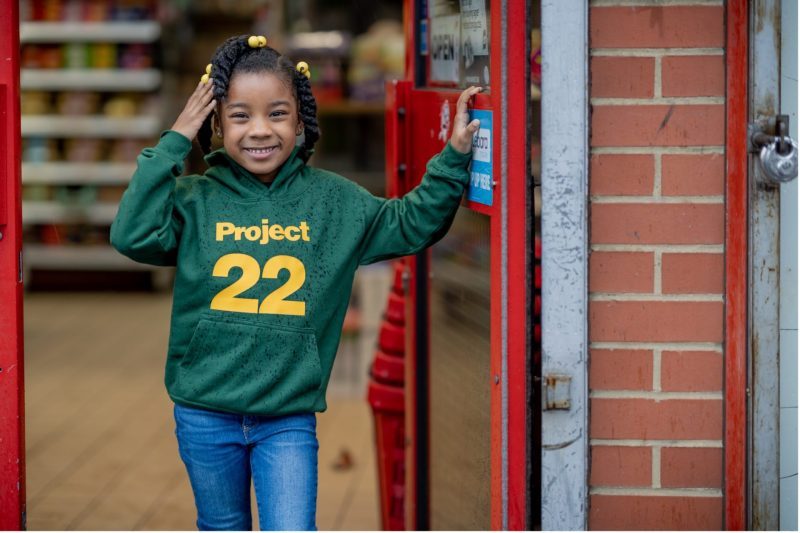 Photo of Naomi wearing a Project 22 hoodie
