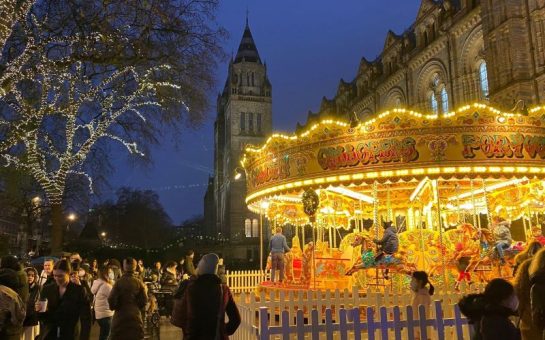 Night-time scene with a lit-up carousel and Christmas lights