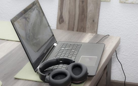 A laptop and headphones on a desk
