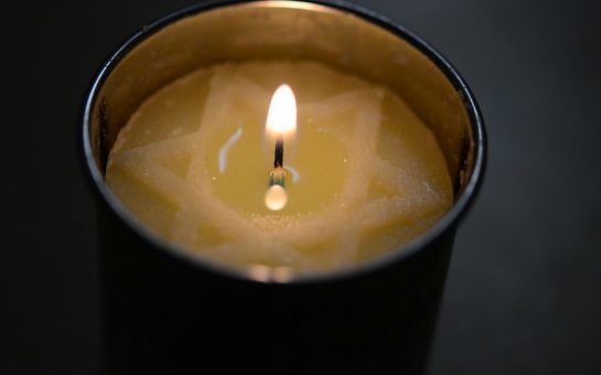 A candle lit for Holocaust Memorial Day