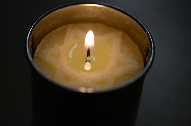 A candle lit for Holocaust Memorial Day