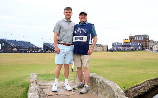 World No.1 disabled golfer Kipp Popert standing on the 18th hole at St Andrews with his dad. He is competing in Celebration of Champions at St Andrews as part of the R&A’s celebrations for the 150th Open.