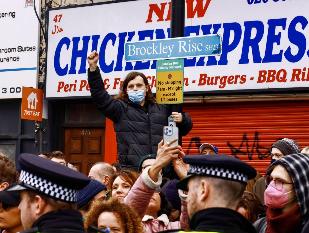 Protester climbs lamppost