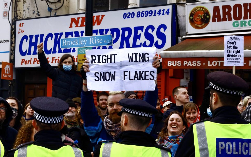 Left-wing protester holds placard