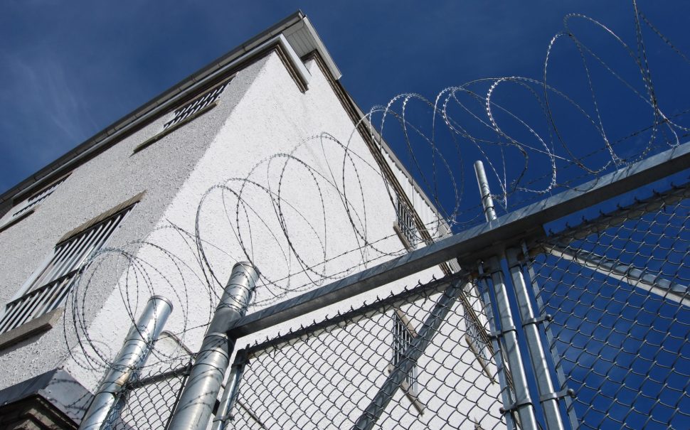 Stock image of outside of a prison.