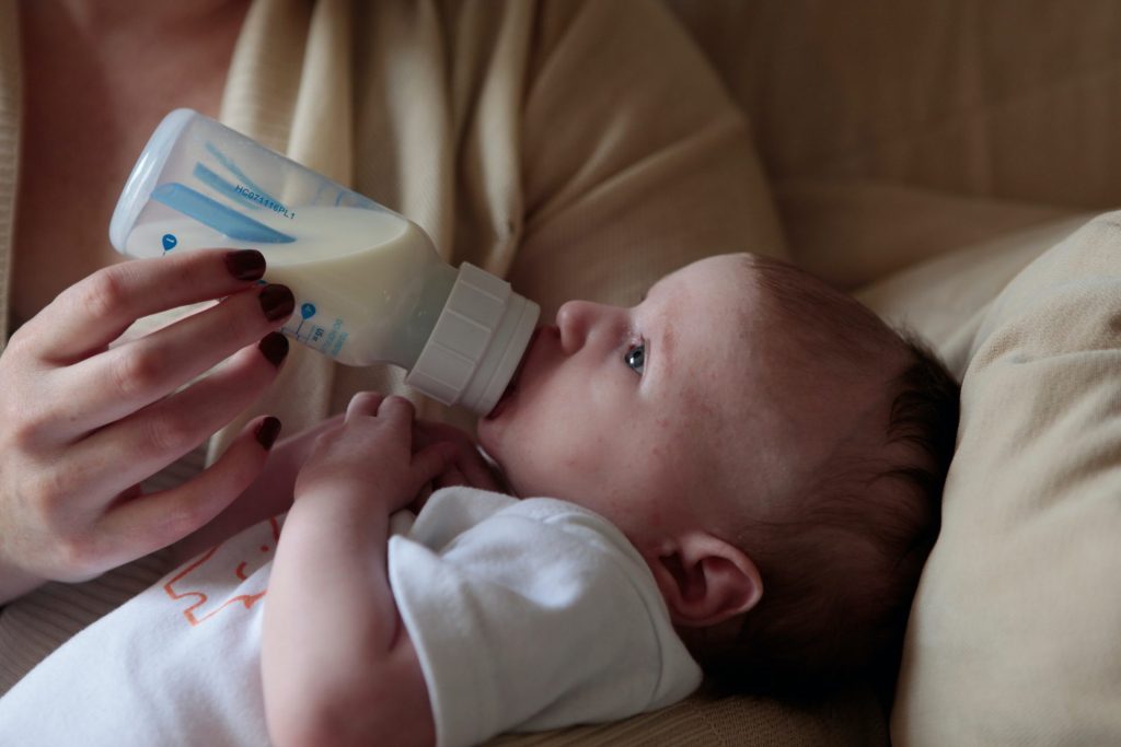 A baby being fed with a bottle in an article about Havering council's breast milk substitute ban.
