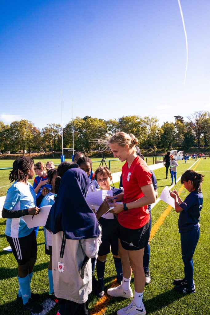 Chelsea women's footballer signing the girl players autographs