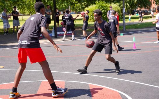 Two young boys playing basketball