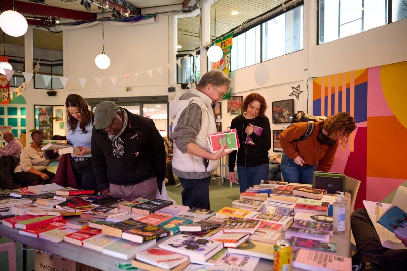 People browsing the Book Swap at Deptford Literature Festival 2024.