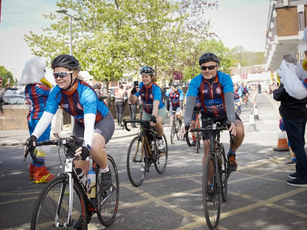 Pack of riders cross the finish line of Bike from Bournemouth charity bike ride
