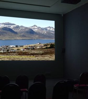 An empty cinema, at Southwark Park Galleries showcasing the film Wild Geese 2: Wilder Geese by Elinor O'Donovan on screen.