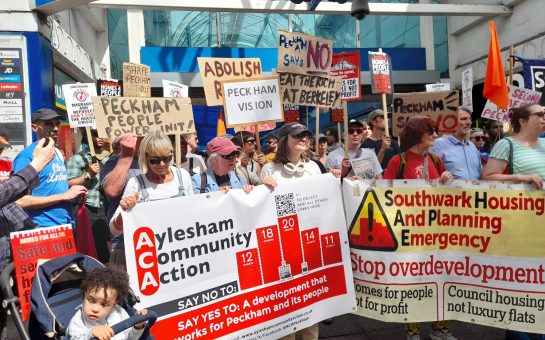 Aylesham Community Action holding protest signs outside of the Aylesham centre