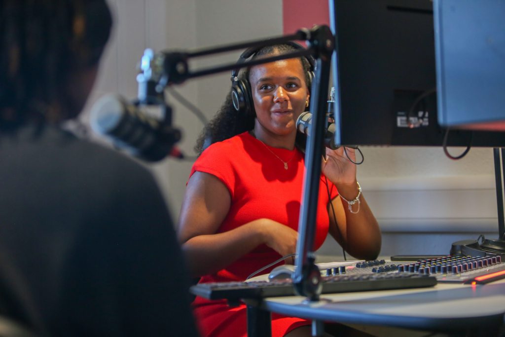 A radio host speaks into a microphone