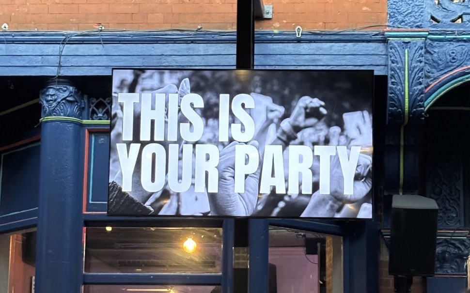 TV screen at a bar showing 'This is Your Party'