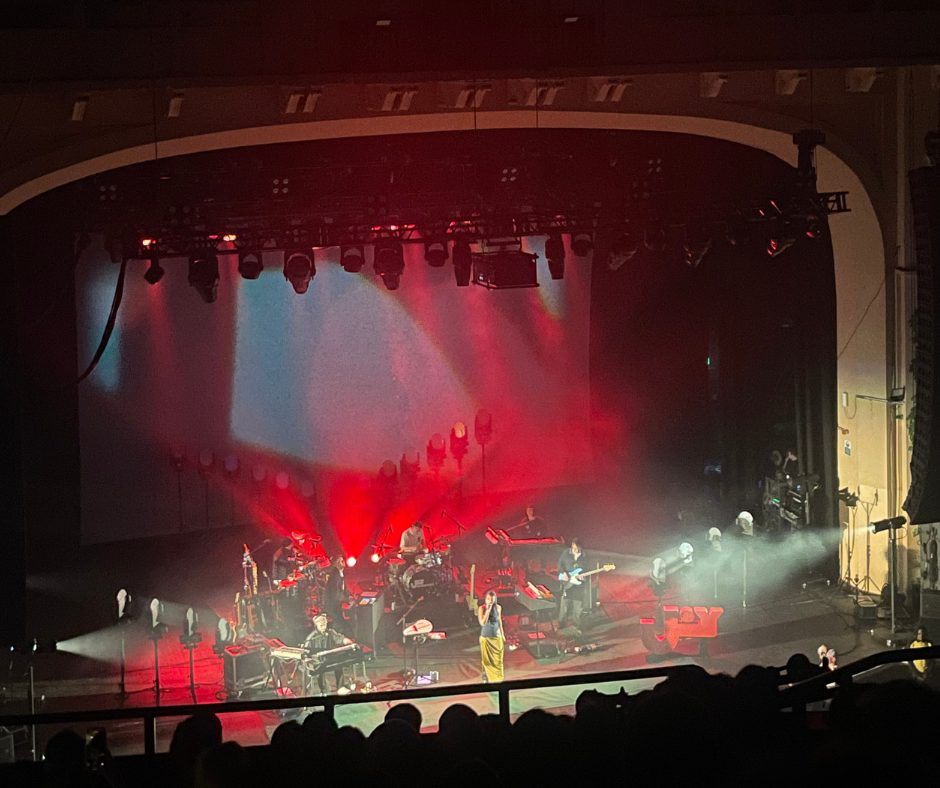 View down to the stage, five person band and Joy Crookes in the middle.