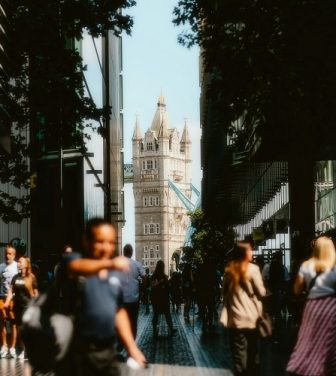 A picture of Tower bridge with crowds of people in the sunshine. Photo by Alin Gavriliuc on Unsplash