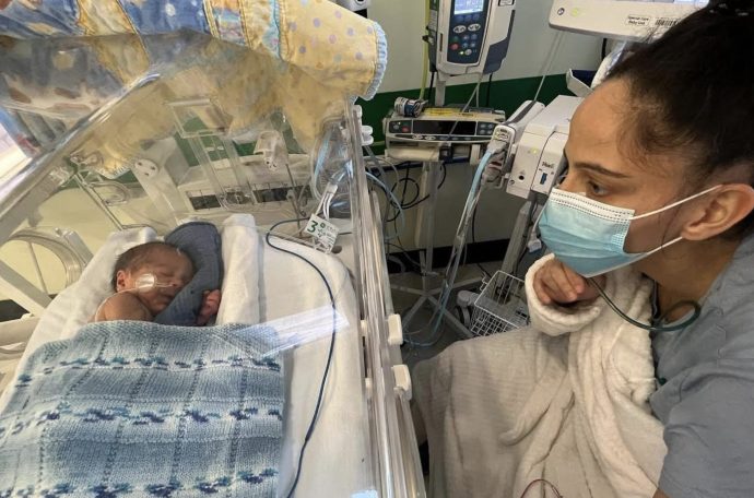 Mother, Eleasha, visits her baby