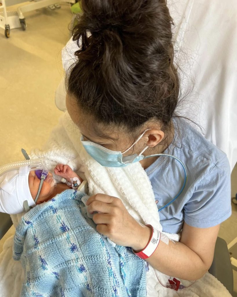 Mother, Elleasha, cradles her newborn baby