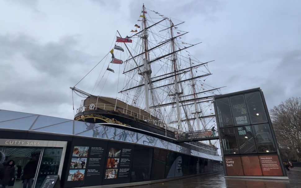 The Victorian merchant ship the Cutty Sark stands against an overcast sky.