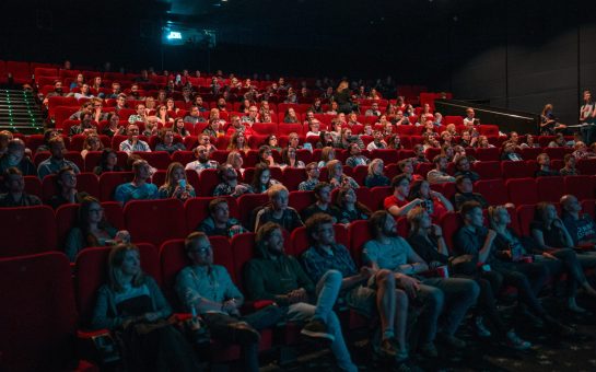 A photo of people in a cinema watching game of thrones