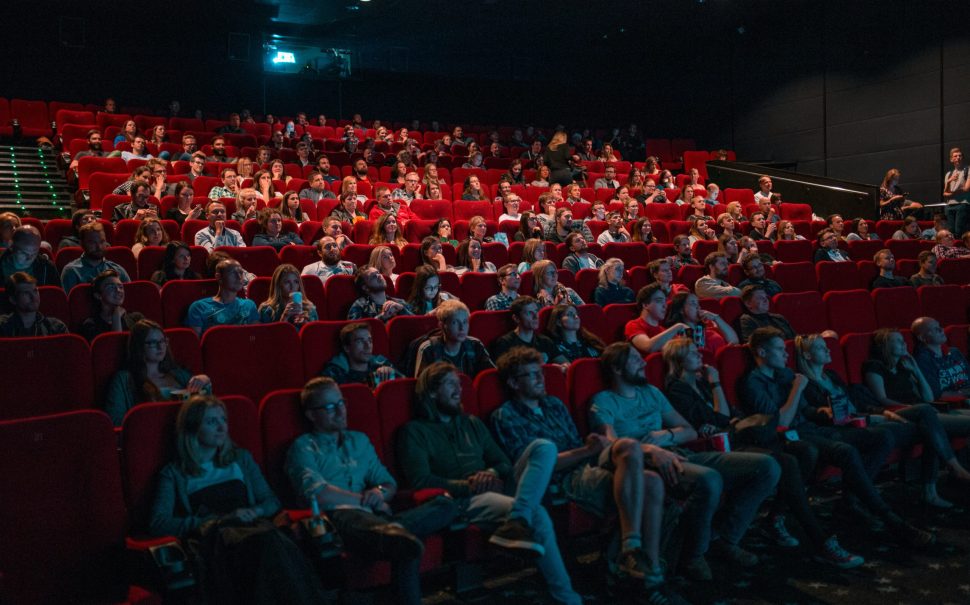 A photo of people in a cinema watching game of thrones