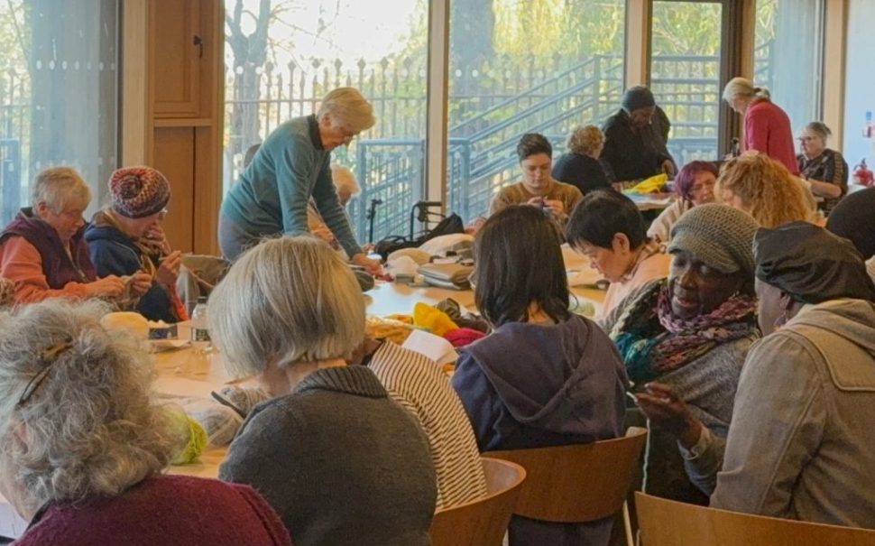 women sitting in a knitting group