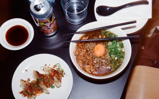 Table with ramen, gyoza and drinks at a restaurant