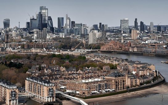 An overhead view of London with the Thames and lots of buildings in view