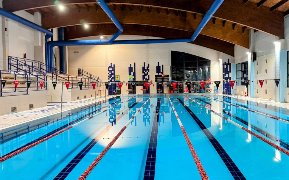 An indoor swimming pool with flags and lanes