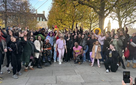 A group of Londoners posing by the River Thames