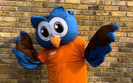 Owl mascot waves for the camera