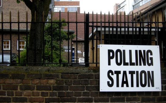 Polling station sign on gate (Credit: Martin Deutsch via Flickr)