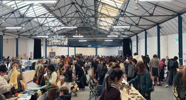 Root Market taking place with a packed crowd browsing the traders on show.