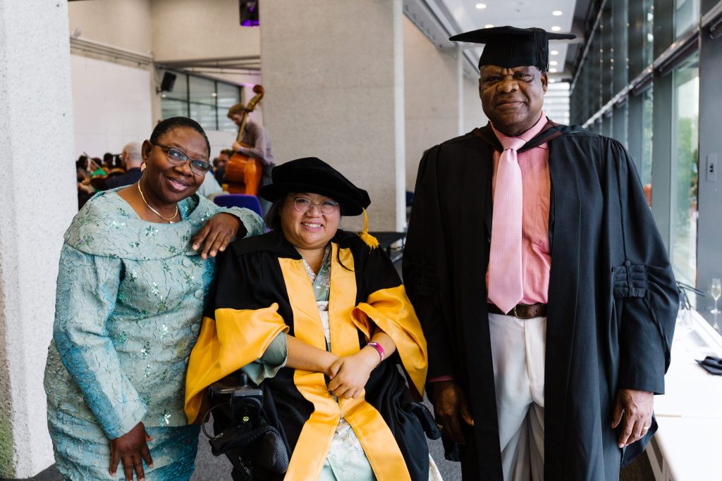 Chris Osagbaekhoe, Ayo Osagbaekhoe and Dr Carmen Yau stand together, smiling.