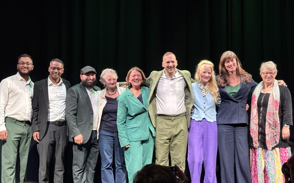 Green Party Leader Zack Polanskio on stage in a group photo with his party