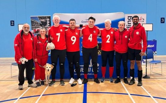 A photo of the London Elephants Goalball team in a sports hall.