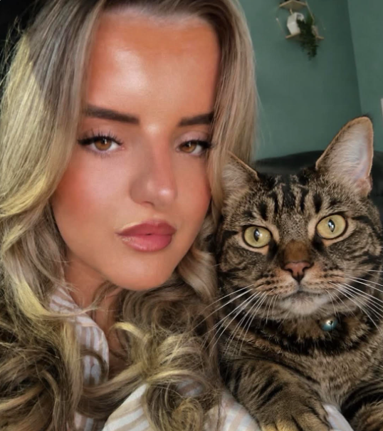 Woman next to tabby cat