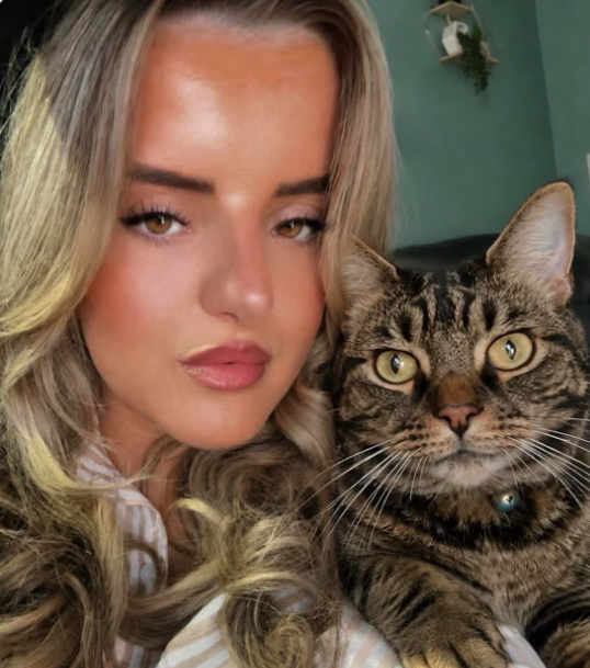 Woman next to tabby cat