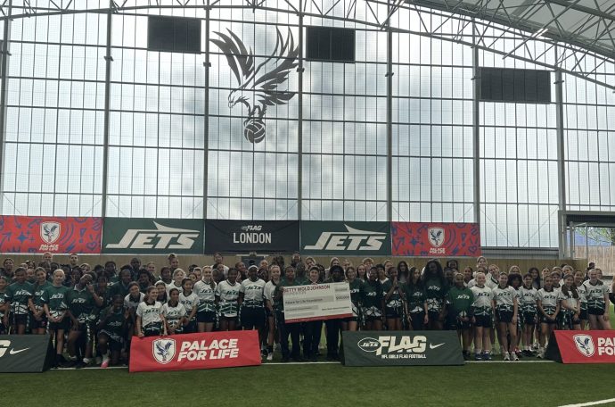 NFL New York Jets launch event with Palace for Life Foundation. Eight schools in attendance with 90 pupils facing camera behind advertising boards.