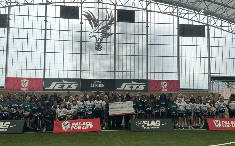 NFL New York Jets launch event with Palace for Life Foundation. Eight schools in attendance with 90 pupils facing camera behind advertising boards.