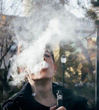Teen vaping in a park